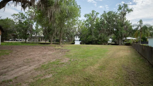 a view of a field with trees in front of it