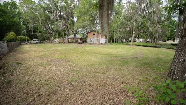 a view of a house with a yard and sitting area