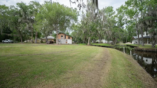 a view of a house with a yard and sitting area