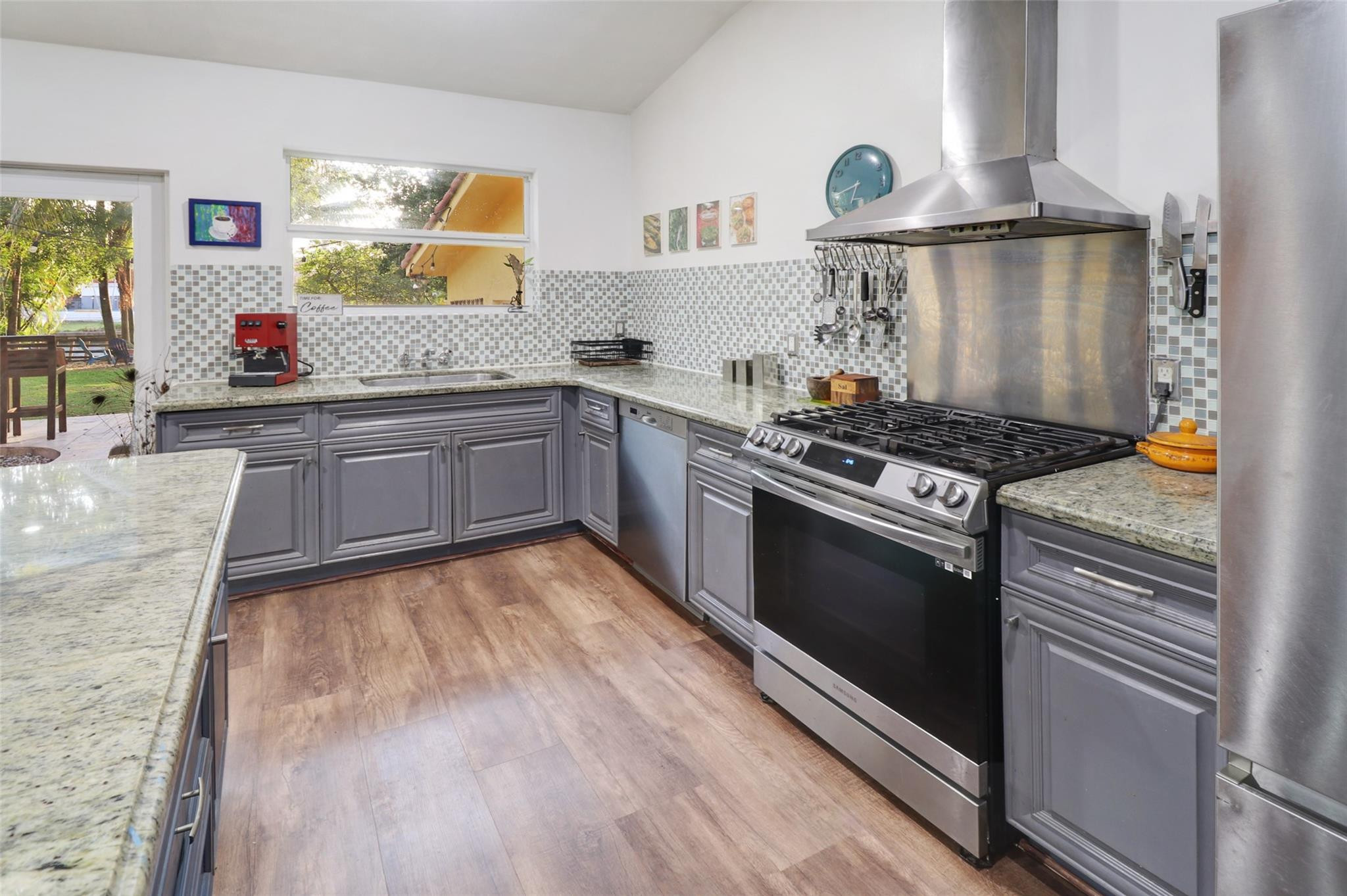 11410 Griffing Boulevard Miami, FL 33161 - Photo 12 of 42 a kitchen with granite countertop a stove and a sink