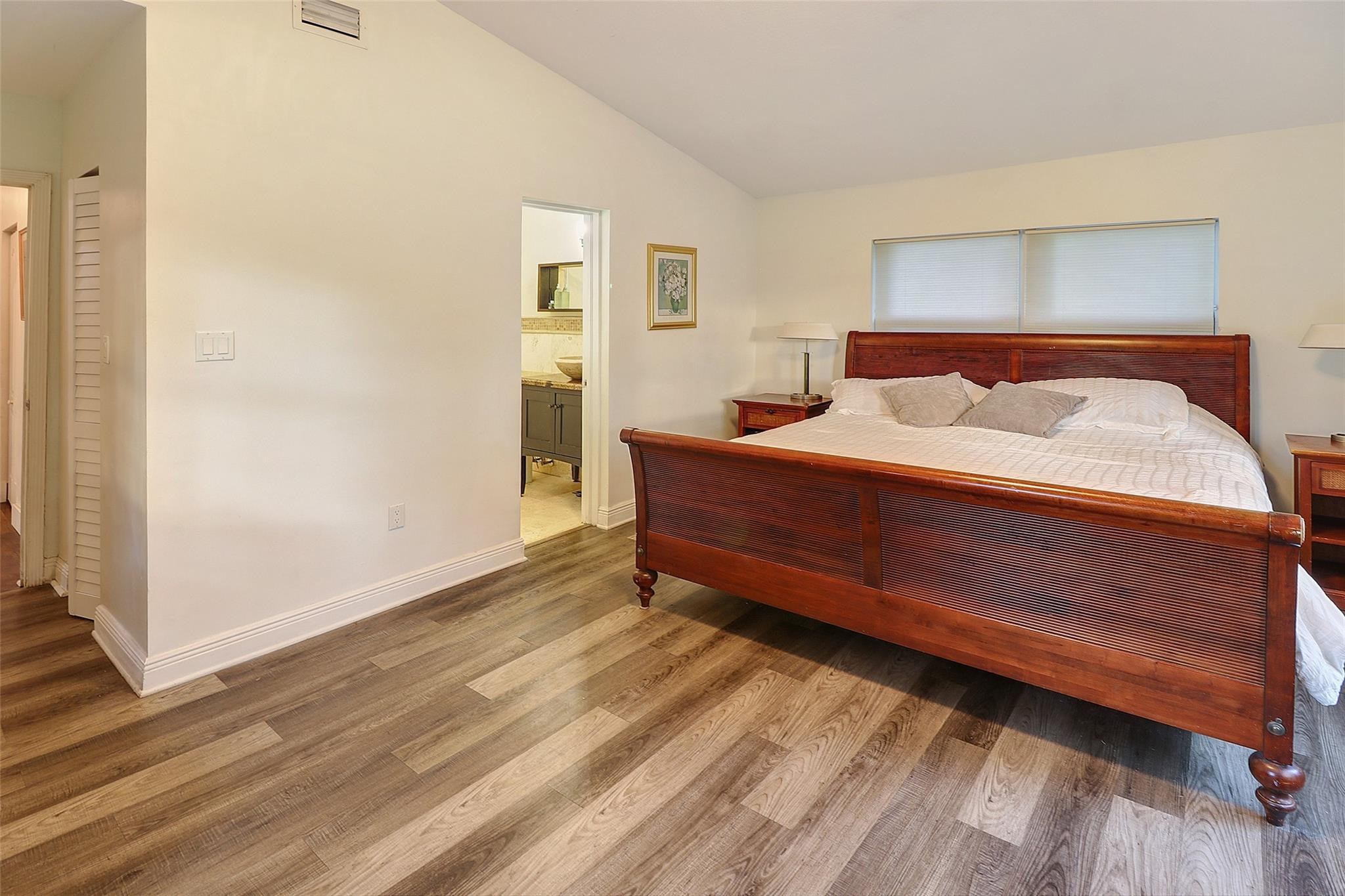 11410 Griffing Boulevard Miami, FL 33161 - Photo 16 of 42 a bedroom with a bed and a mirror