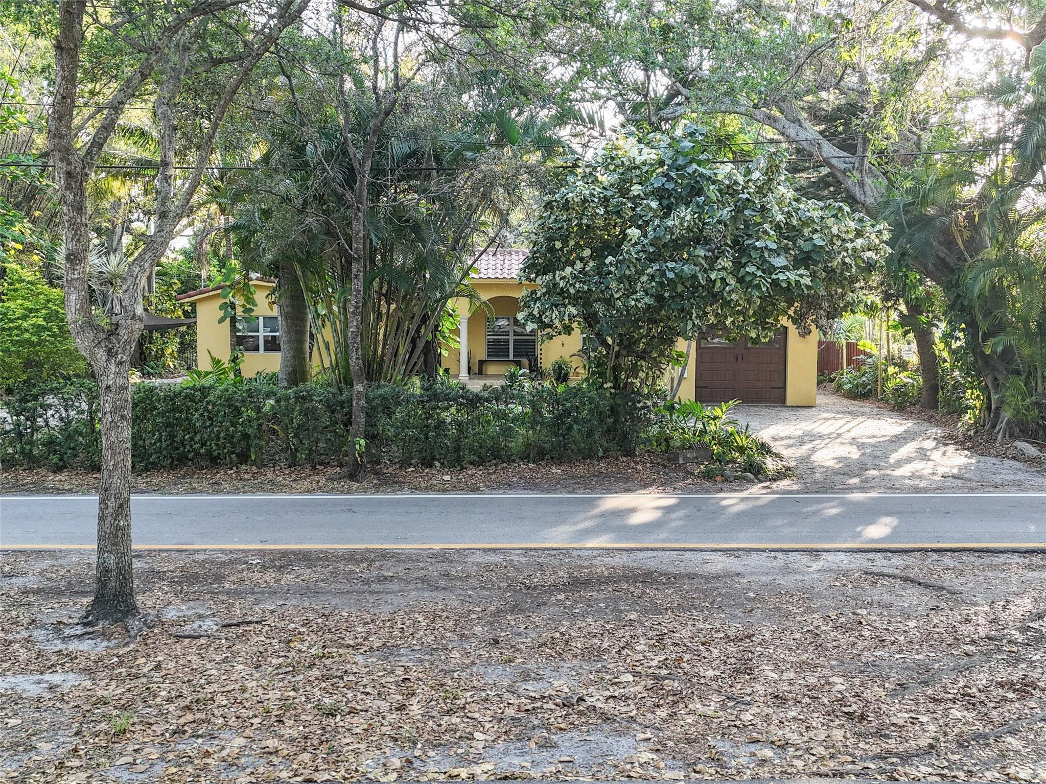 11410 Griffing Boulevard Miami, FL 33161 - Photo 39 of 42 a view of a yard with plants and large trees