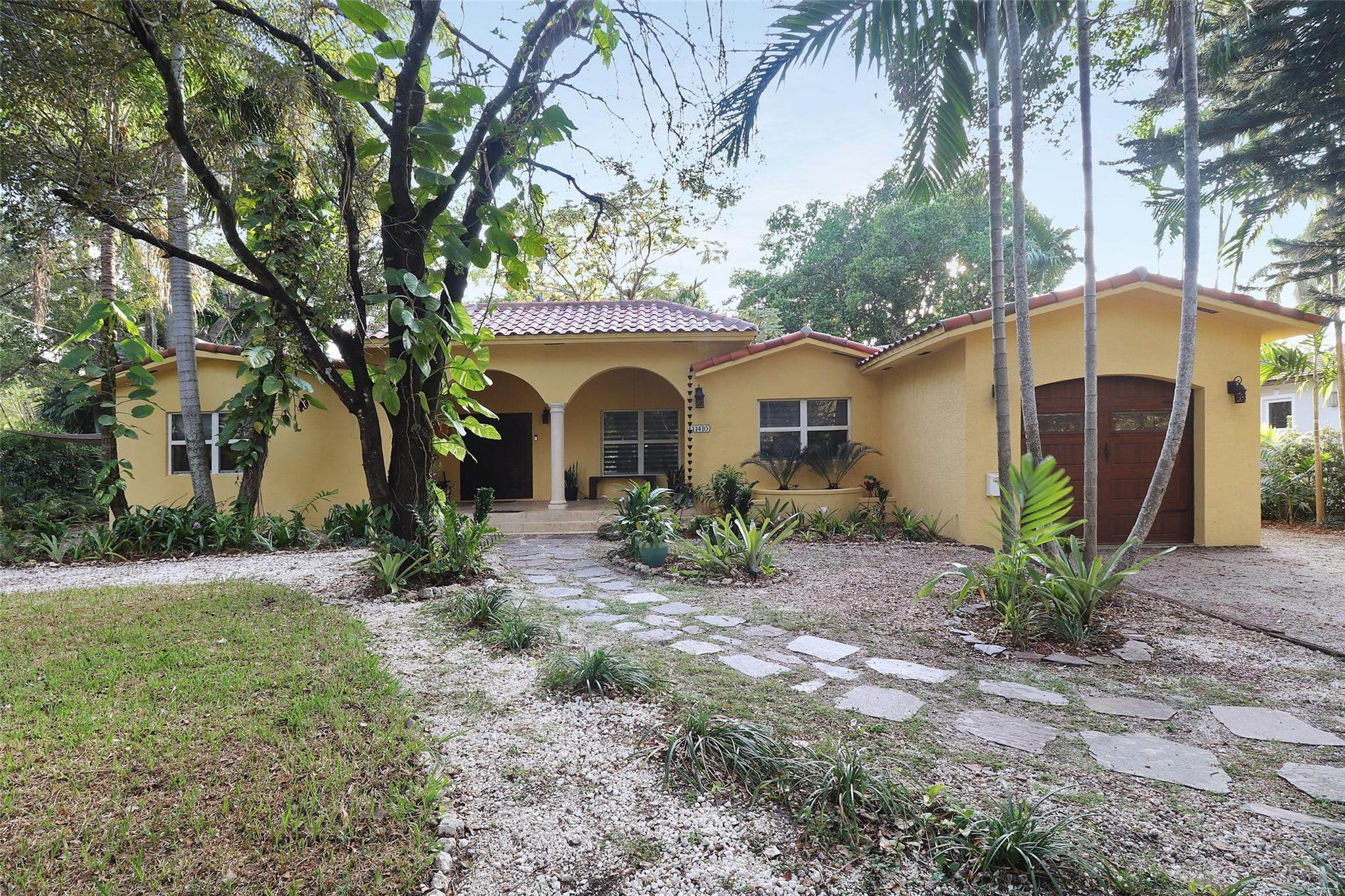 11410 Griffing Boulevard Miami, FL 33161 - Photo 4 of 42 a front view of a house with garden