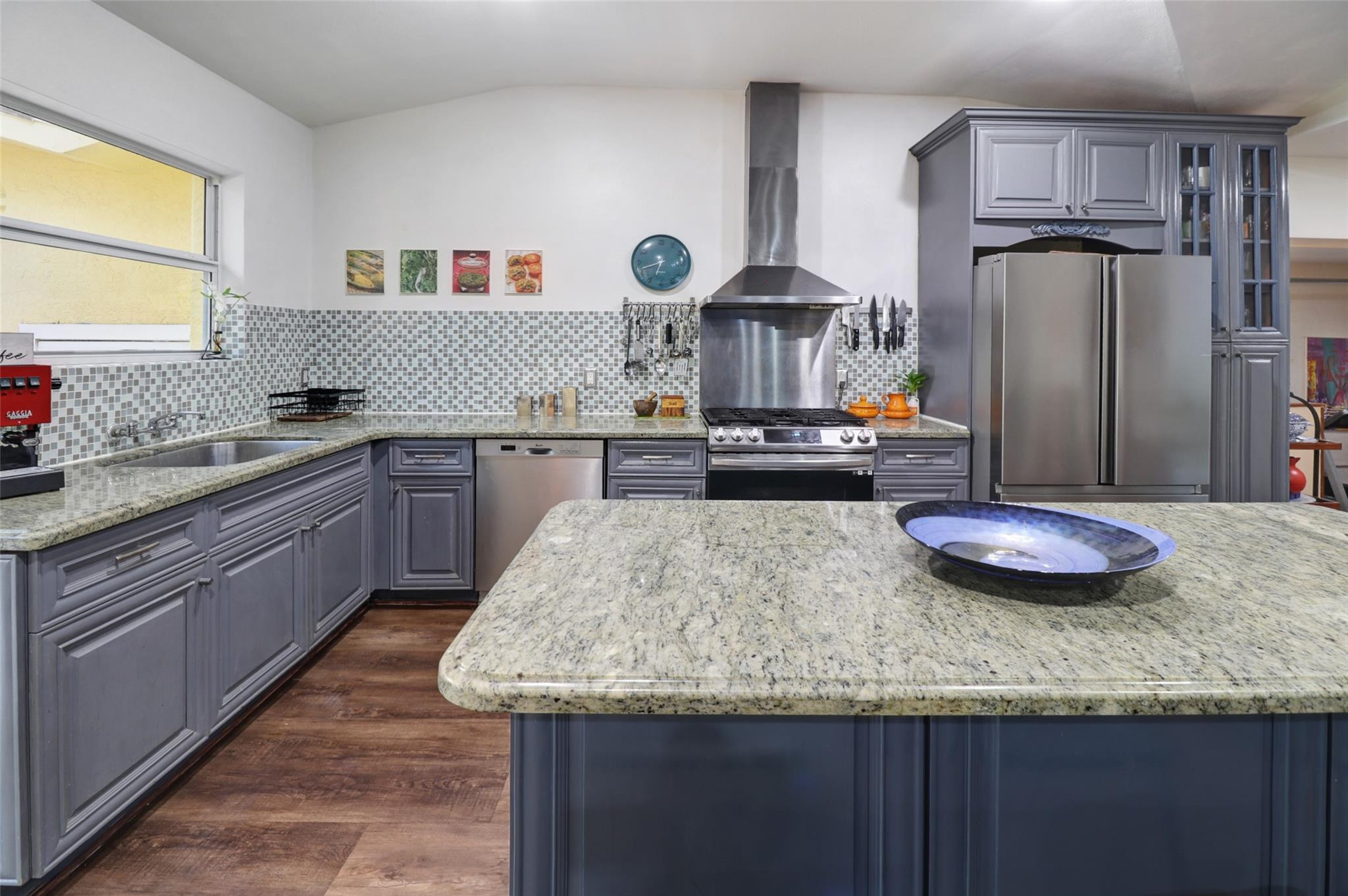 11410 Griffing Boulevard Miami, FL 33161 - Photo 10 of 42 a kitchen with stainless steel appliances granite countertop a sink dishwasher stove and refrigerator with wooden floor