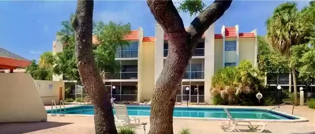 610 Northwest 13th Street, Unit 23 Boca Raton, FL 33486 - Photo 5 of 28 a front view of a house with a yard