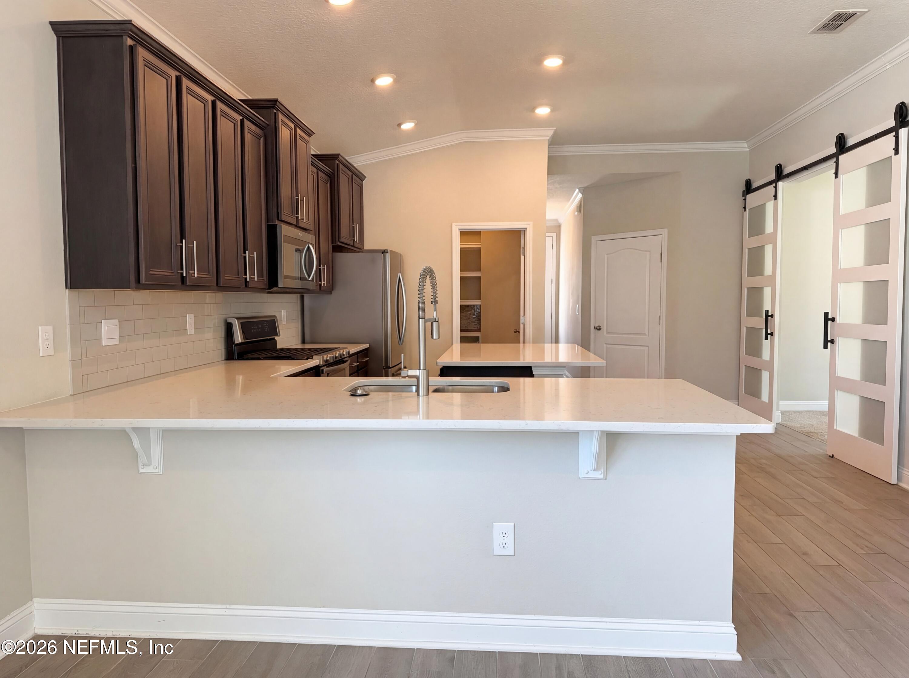 56 Thistleton Way Street St. Augustine, FL 32092 - Photo 13 of 28 a view of kitchen with stainless steel appliances granite countertop a sink a stove and a refrigerator