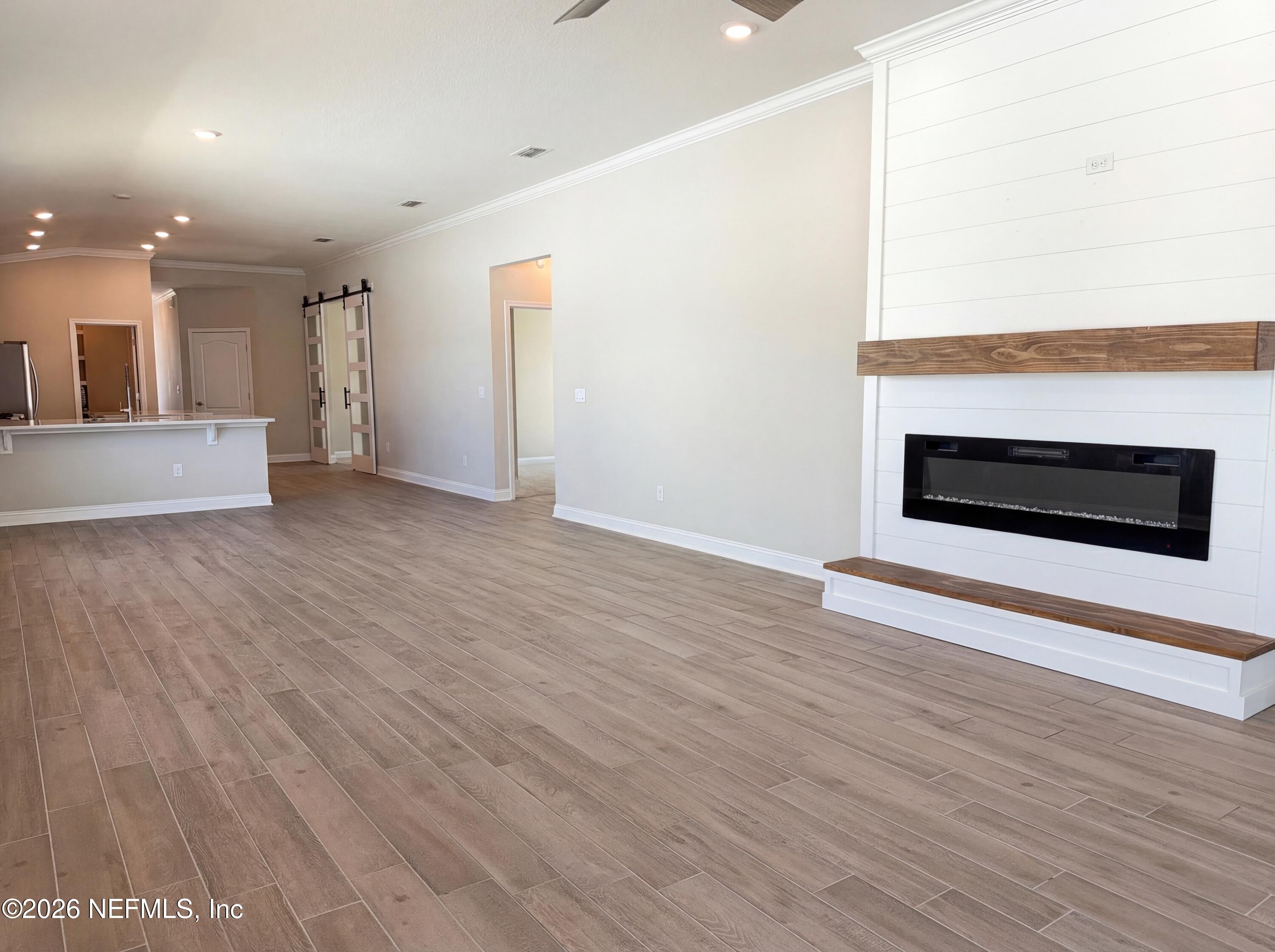 56 Thistleton Way Street St. Augustine, FL 32092 - Photo 14 of 28 a view of an empty room with wooden floor and a fireplace