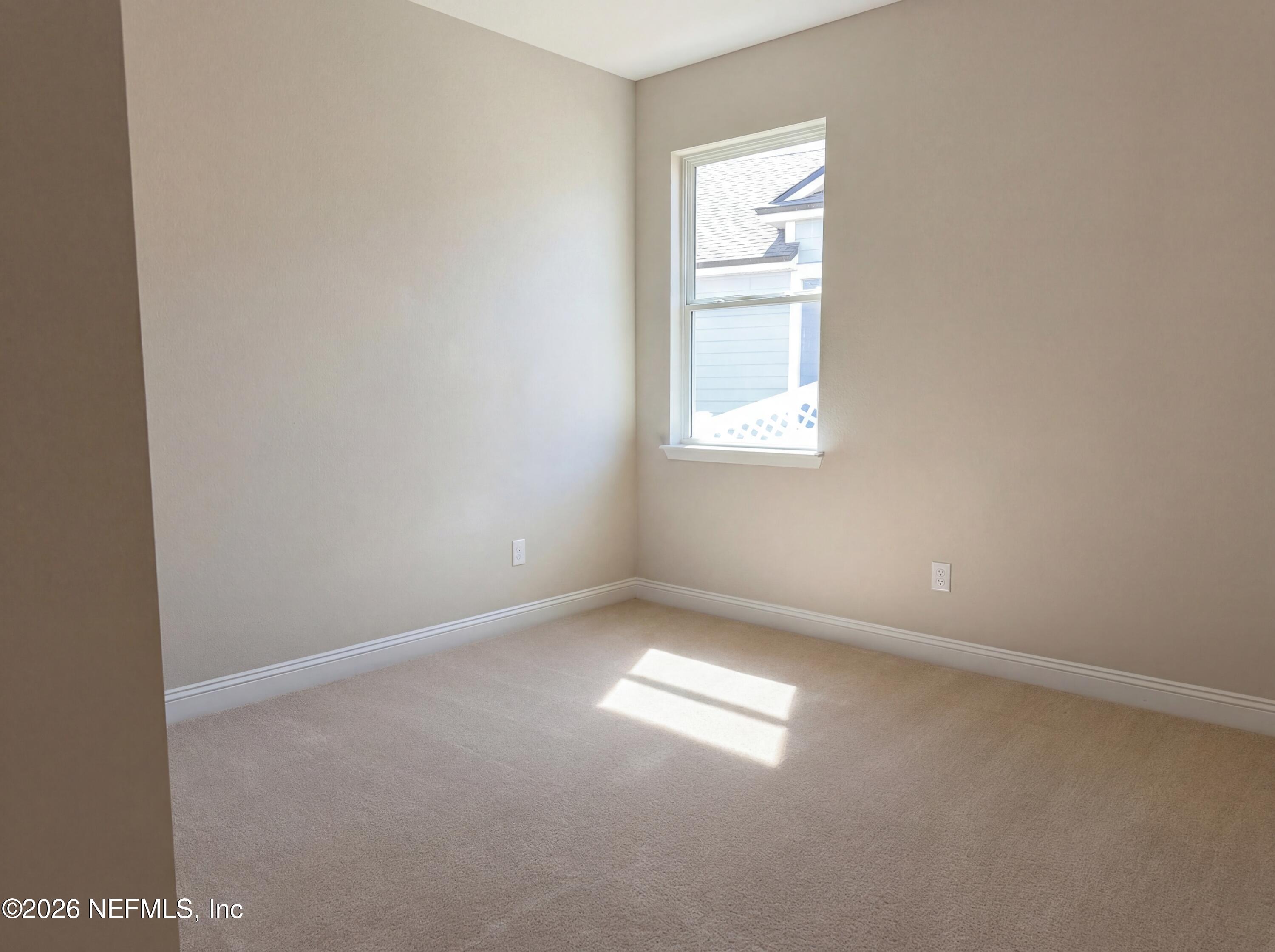 56 Thistleton Way Street St. Augustine, FL 32092 - Photo 20 of 28 an empty room with a window