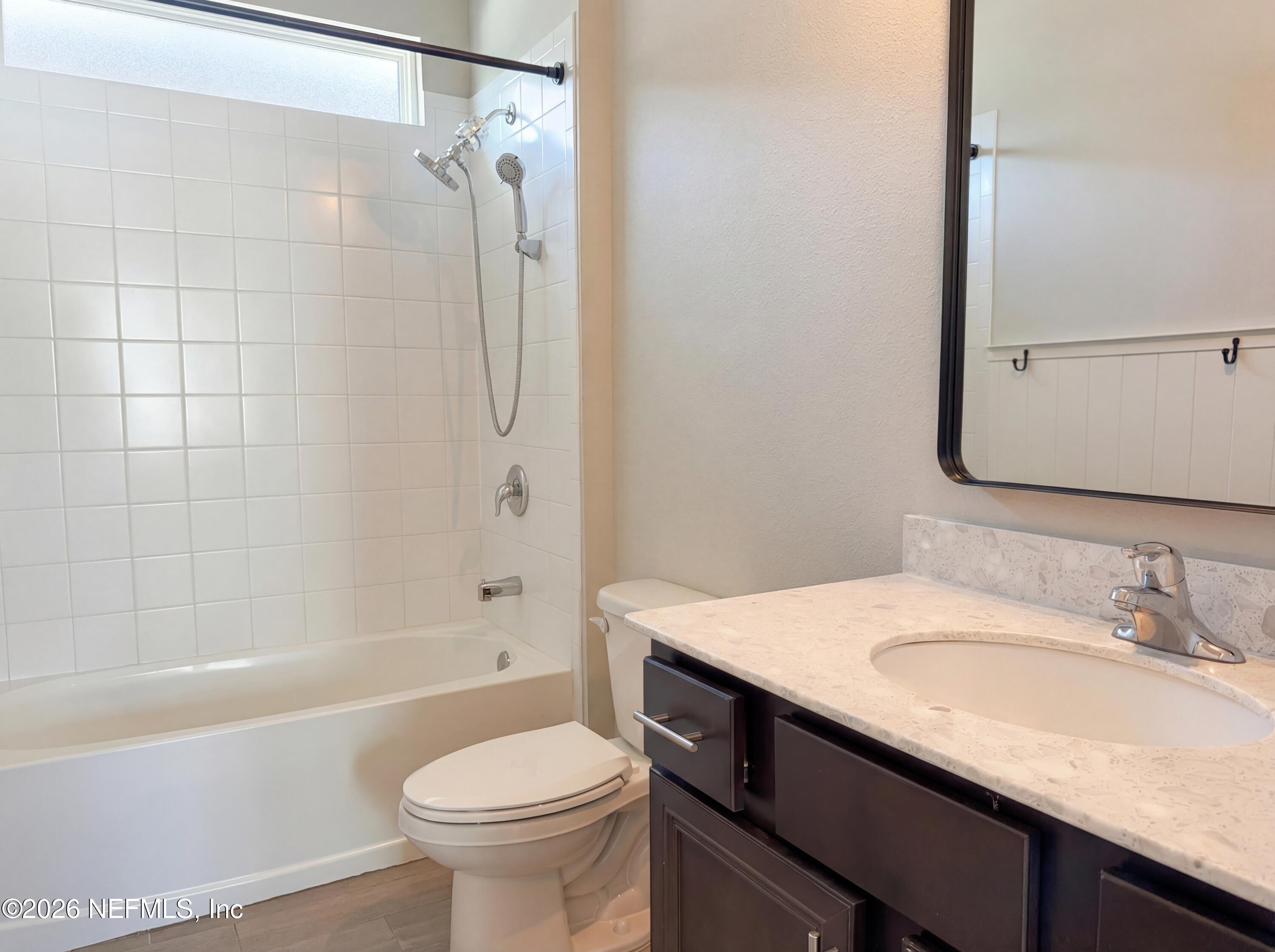 56 Thistleton Way Street St. Augustine, FL 32092 - Photo 22 of 28 a bathroom with a granite countertop sink toilet and shower