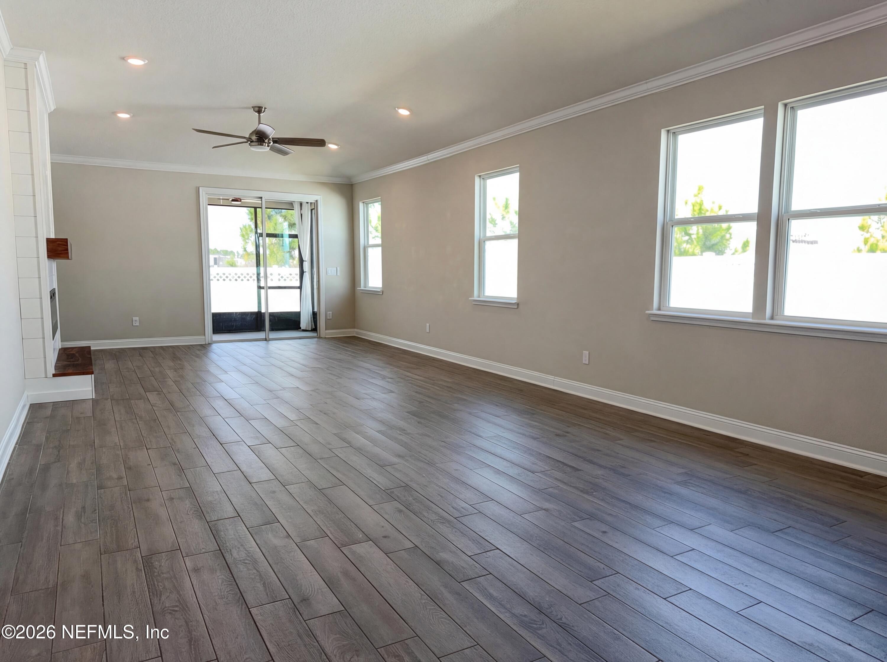 56 Thistleton Way Street St. Augustine, FL 32092 - Photo 3 of 28 an empty room with wooden floor and windows