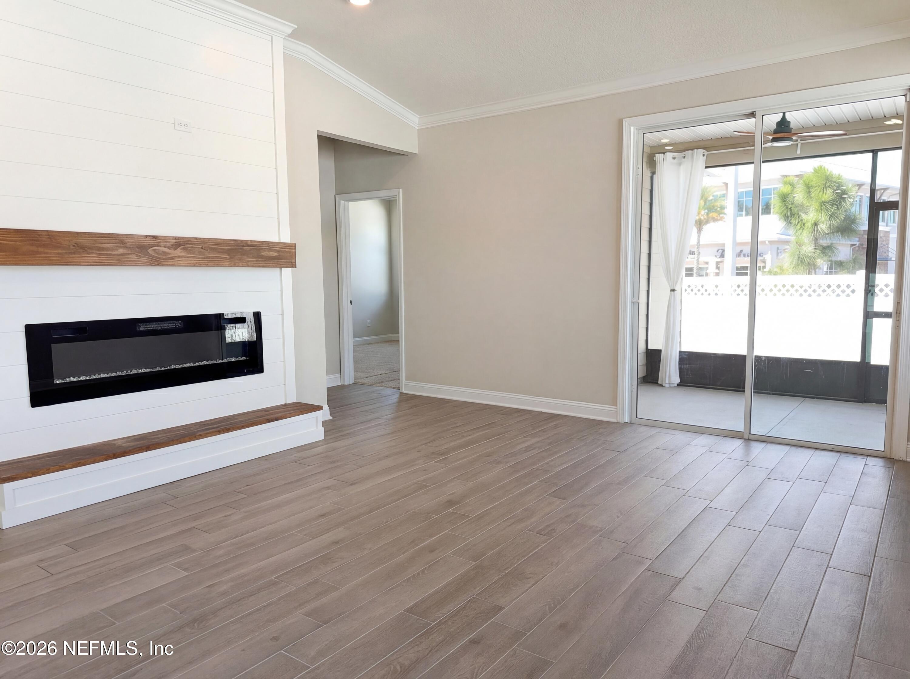 56 Thistleton Way Street St. Augustine, FL 32092 - Photo 6 of 28 an empty room with wooden floor and windows