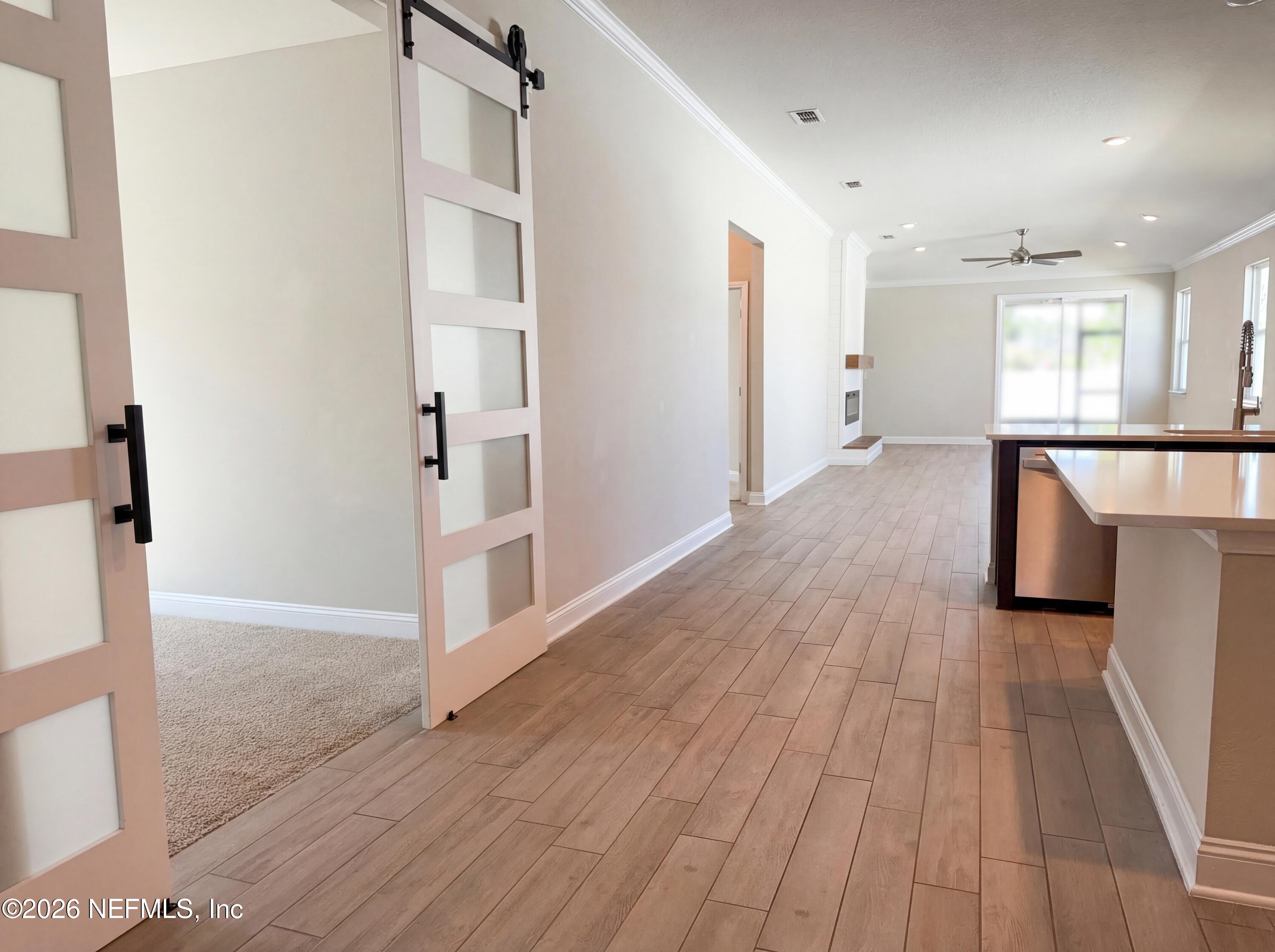 56 Thistleton Way Street St. Augustine, FL 32092 - Photo 9 of 28 a view of a hallway with wooden floor