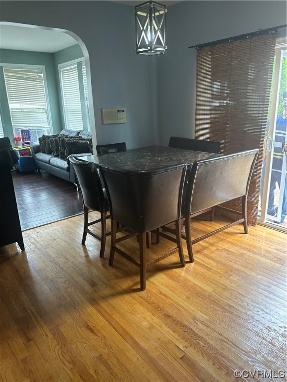 Wood floored dining space featuring a notable chan
