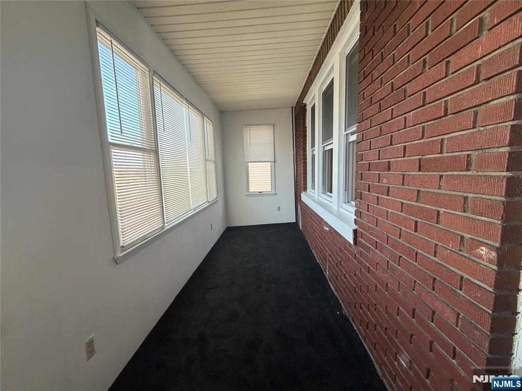 557 Gregory Avenue, Unit 2 Passaic, NJ 07055 - Photo 9 of 9 a view of a hallway with windows