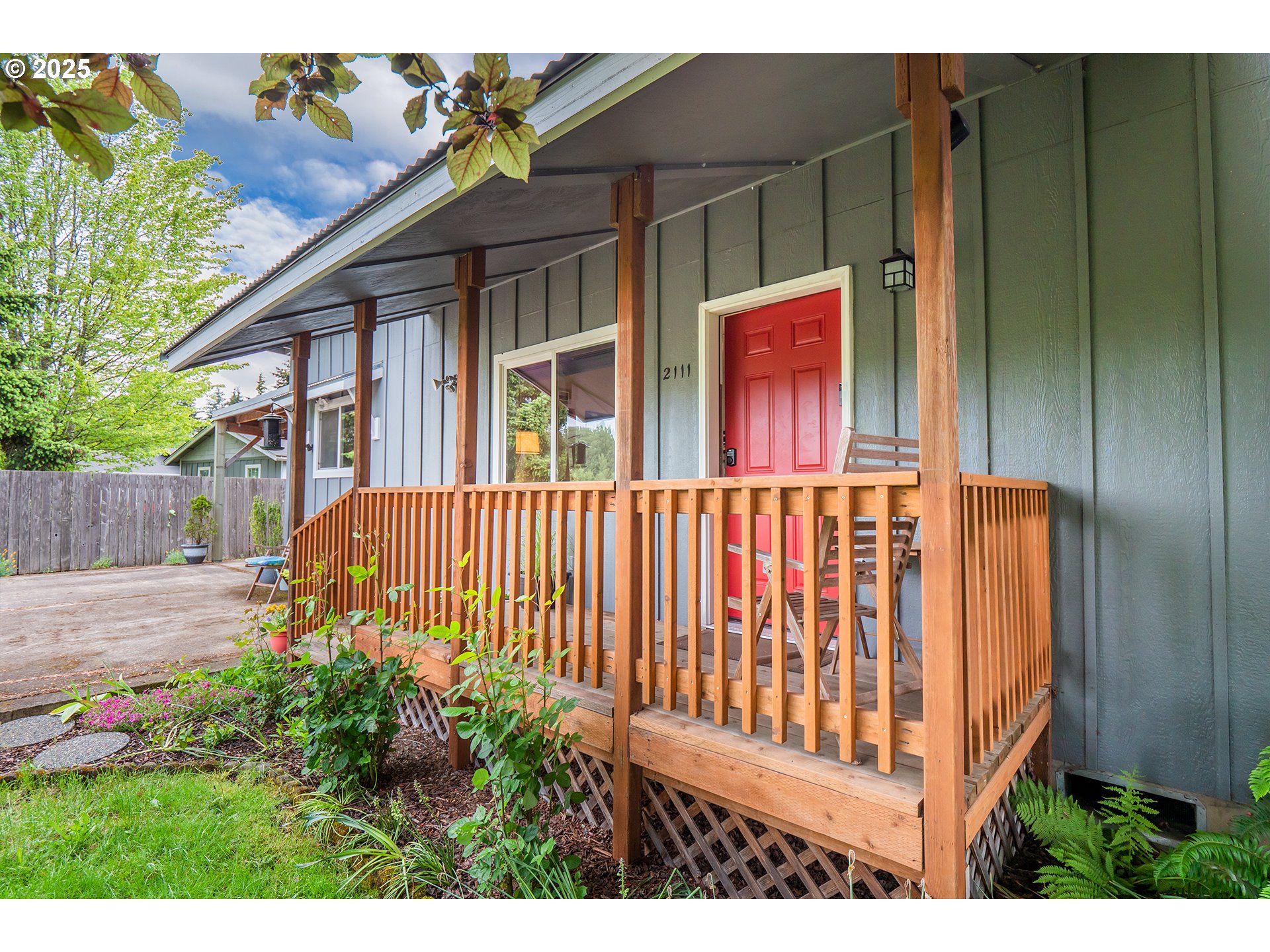 2111 South Bertelsen Road Eugene, OR 97405 - Photo 22 of 32 a view of a house with a small yard and wooden fence