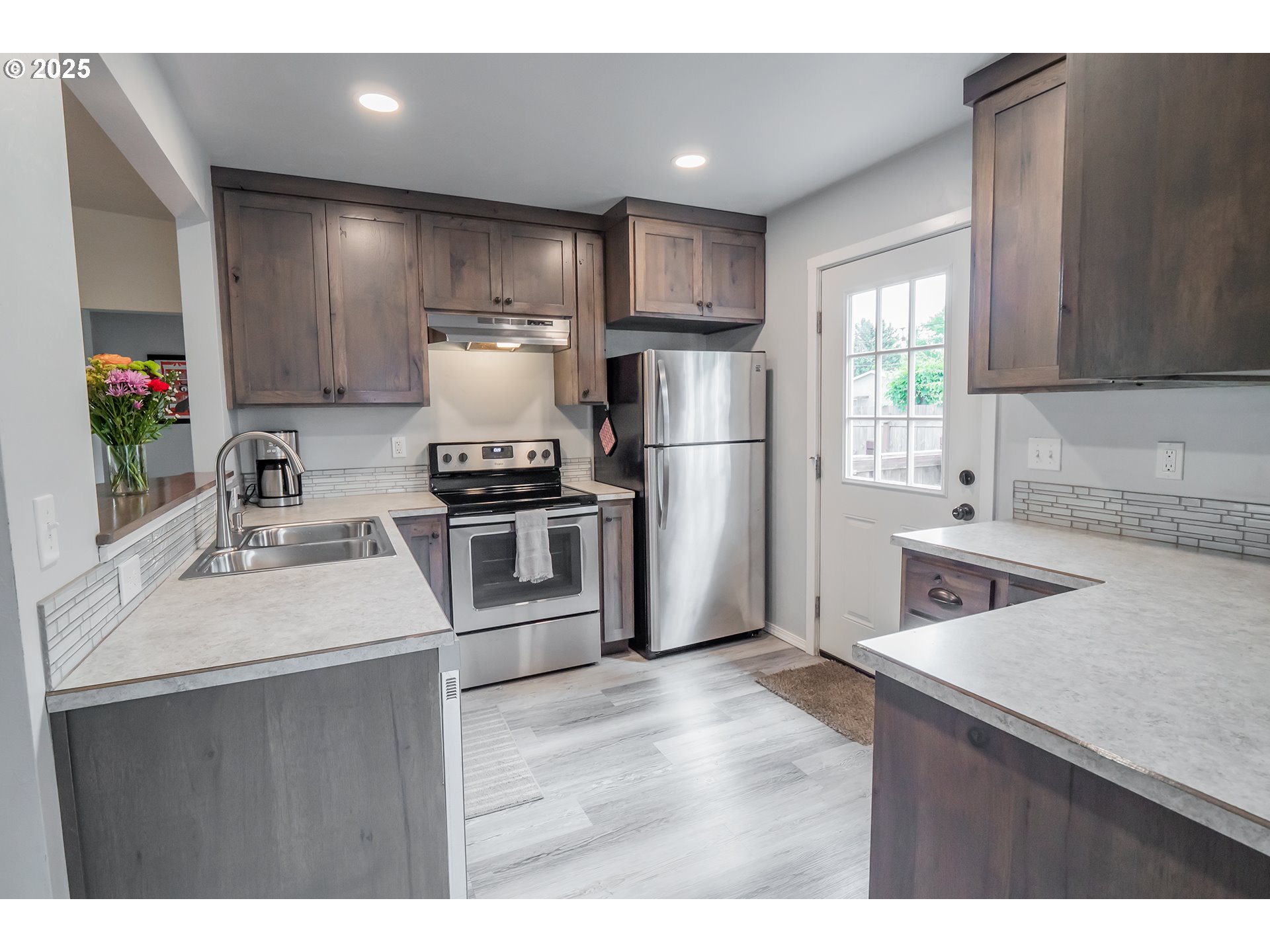 2111 South Bertelsen Road Eugene, OR 97405 - Photo 5 of 32 a kitchen with a sink appliances and cabinets