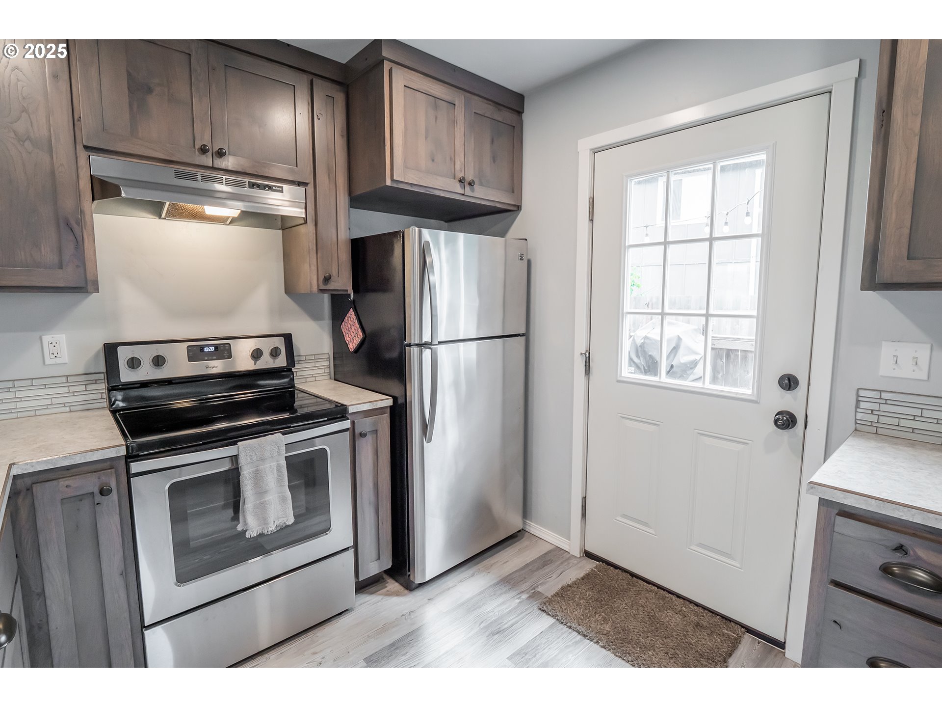 2111 South Bertelsen Road Eugene, OR 97405 - Photo 7 of 32 a kitchen with cabinets and steel stainless steel appliances