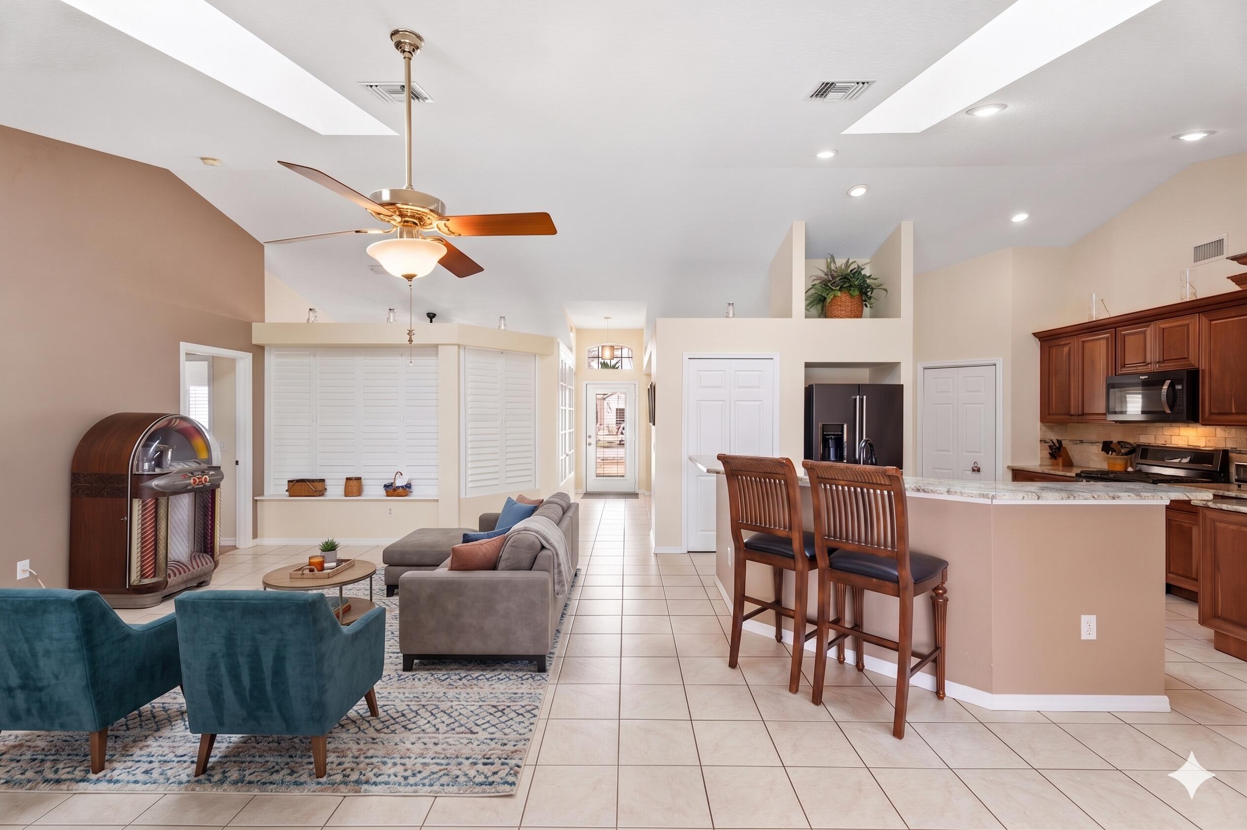 5593 Northwest Wesley Road Port St. Lucie, FL 34986 - Photo 11 of 33 Living room and kitchen virtually staged
