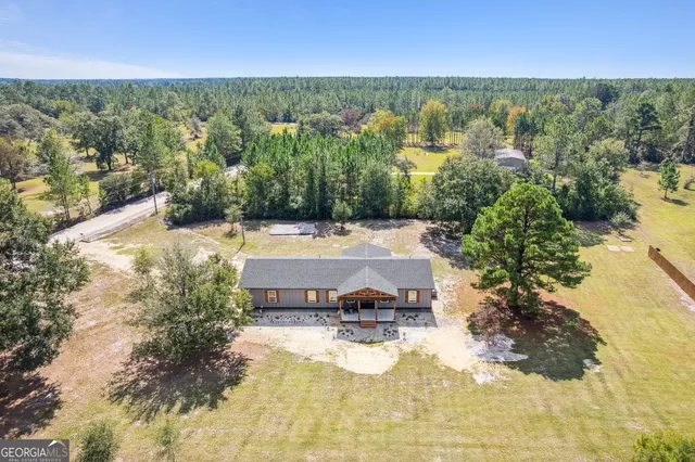 a view of a swimming pool with a yard