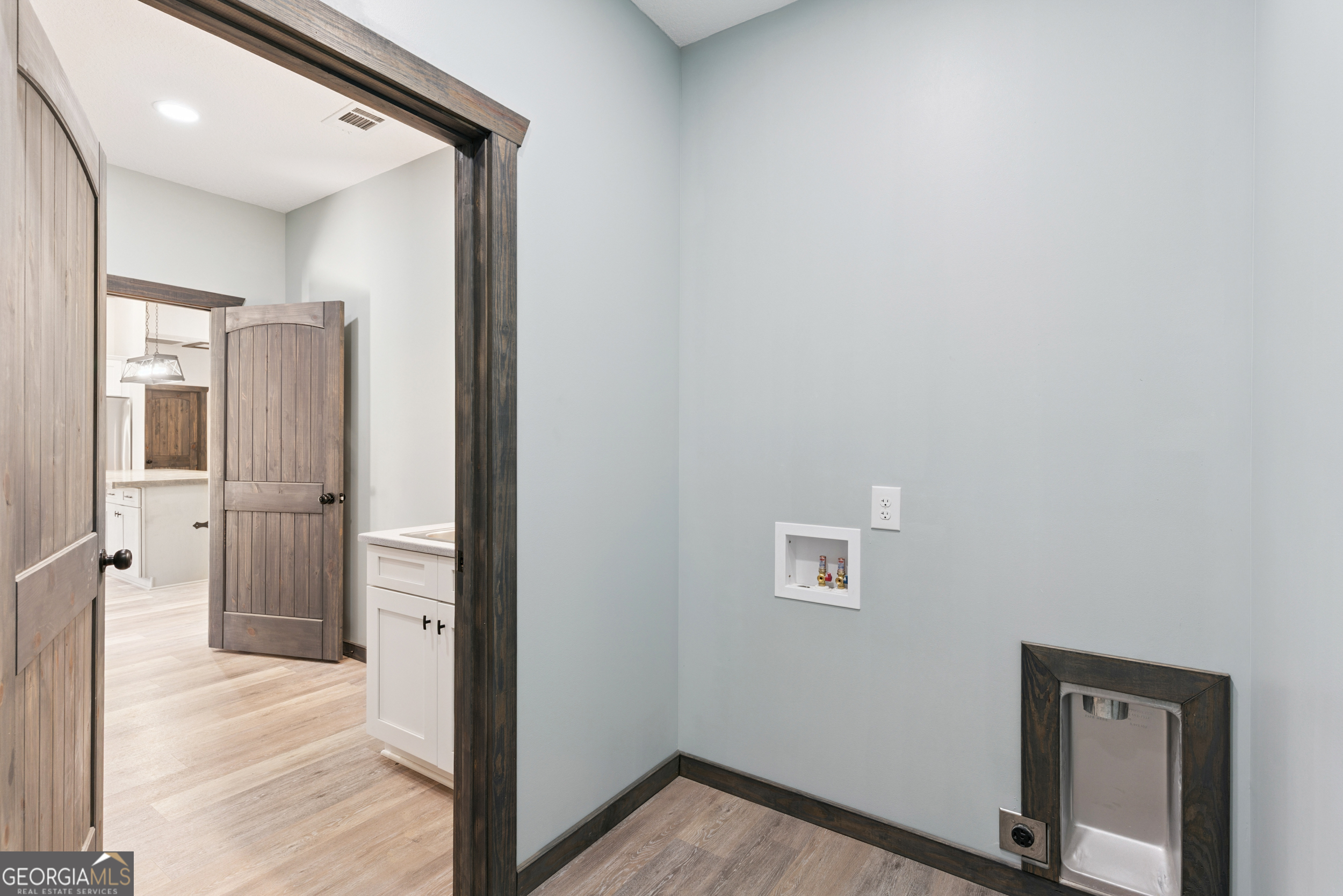 29 Chisholm Street Nahunta, GA 31553 - Photo 16 of 49 a view of a hallway with wooden floor and a living room