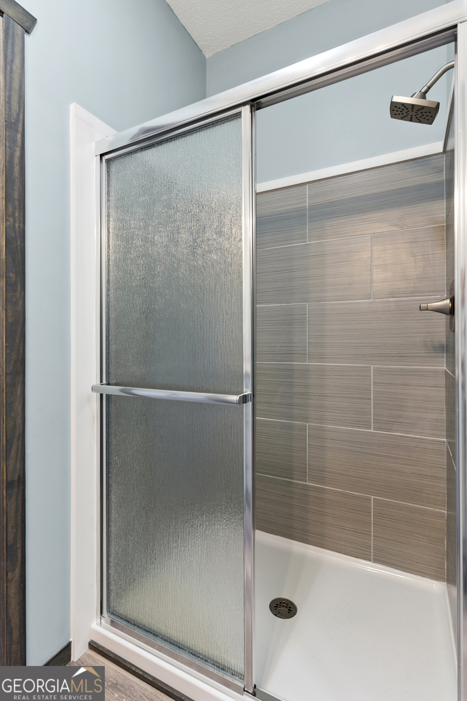 29 Chisholm Street Nahunta, GA 31553 - Photo 18 of 49 a bathroom with a glass shower door