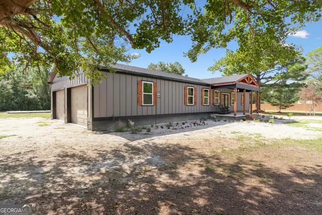 a backyard of a house with wooden fence