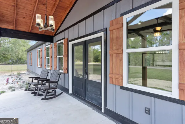 a room with furniture and large windows