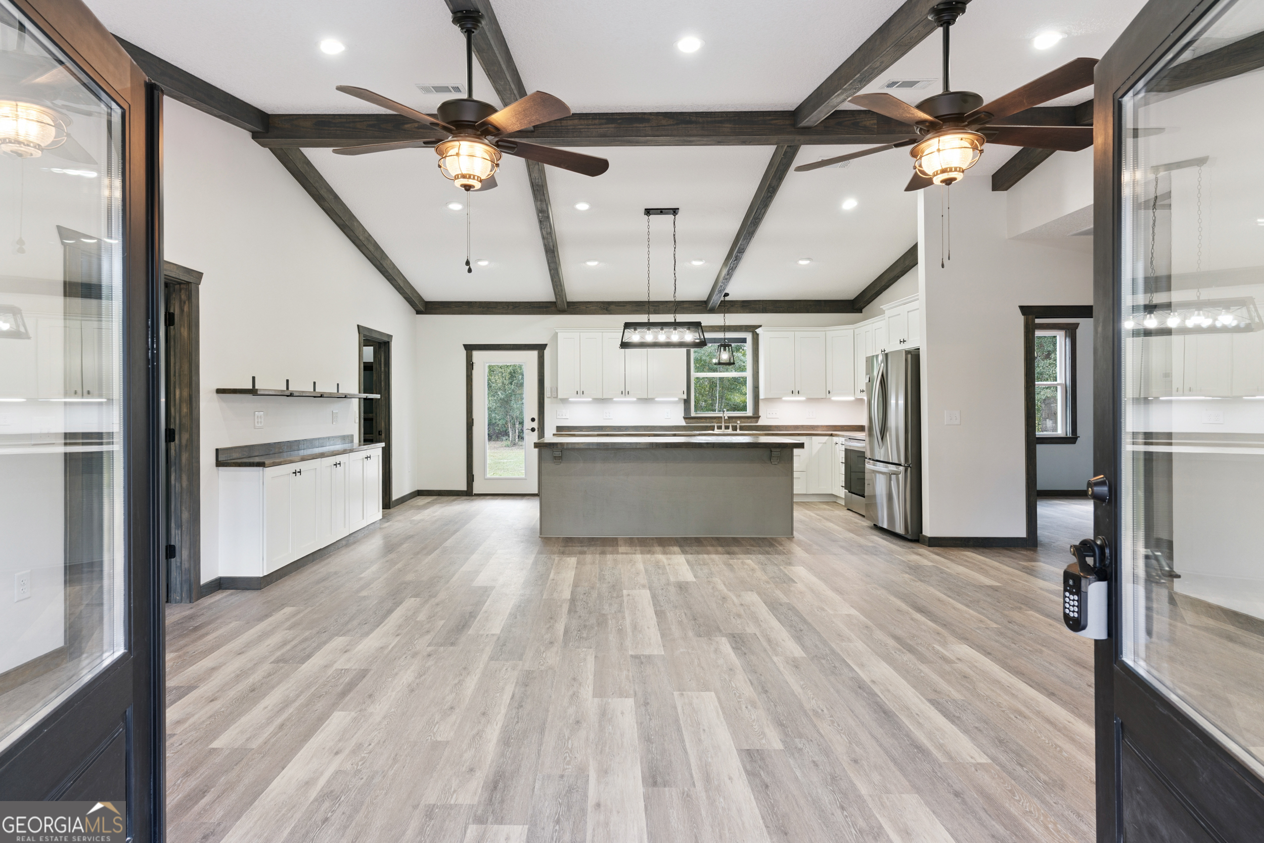 29 Chisholm Street Nahunta, GA 31553 - Photo 6 of 49 a view of a kitchen with a sink refrigerator and wooden floor