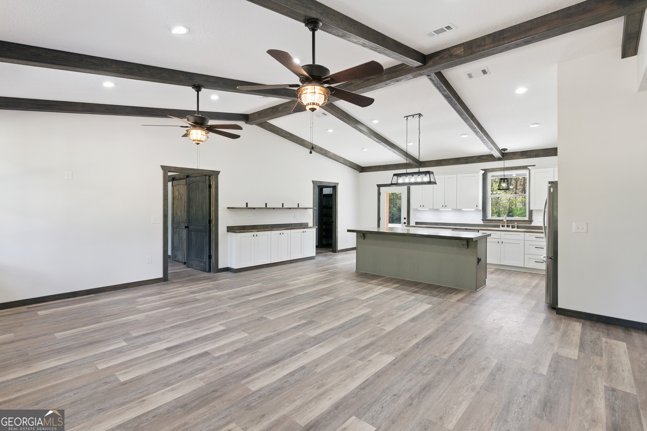 29 Chisholm Street Nahunta, GA 31553 - Photo 7 of 49 a view of a kitchen with a sink and a refrigerator