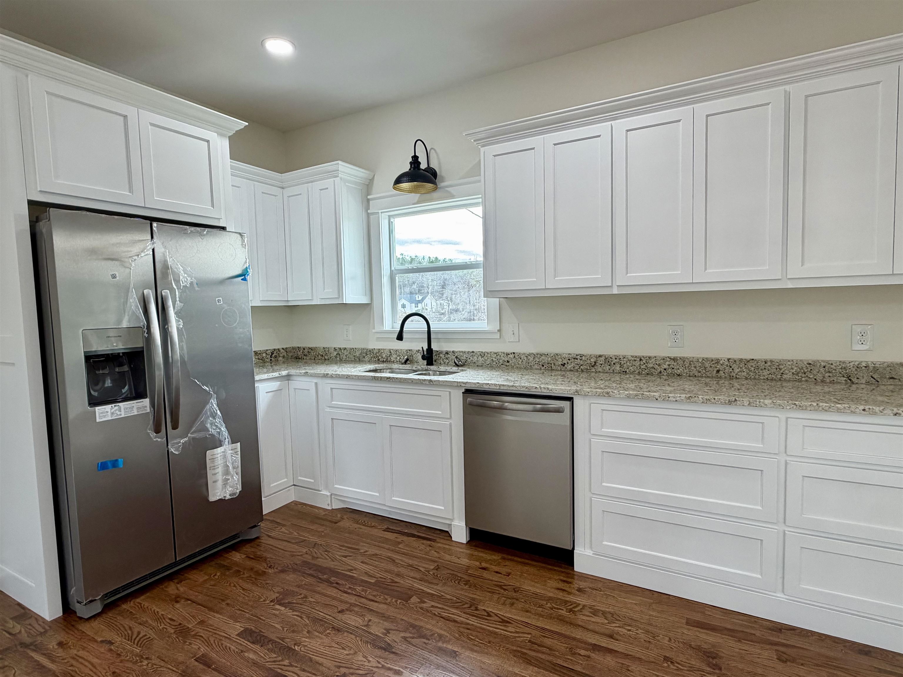 172 New Bethel Road Selmer, TN 38375 - Photo 13 of 30 a kitchen with granite countertop a refrigerator sink and cabinets