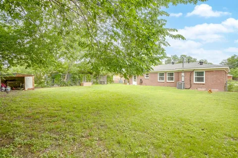 a view of a house with a backyard