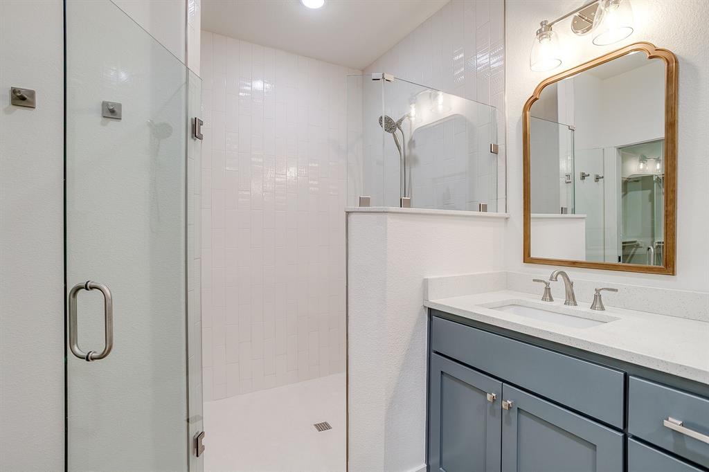 102 Cardinal Wds Granbury, TX 76049 - Photo 21 of 26 a bathroom with a shower sink and mirror