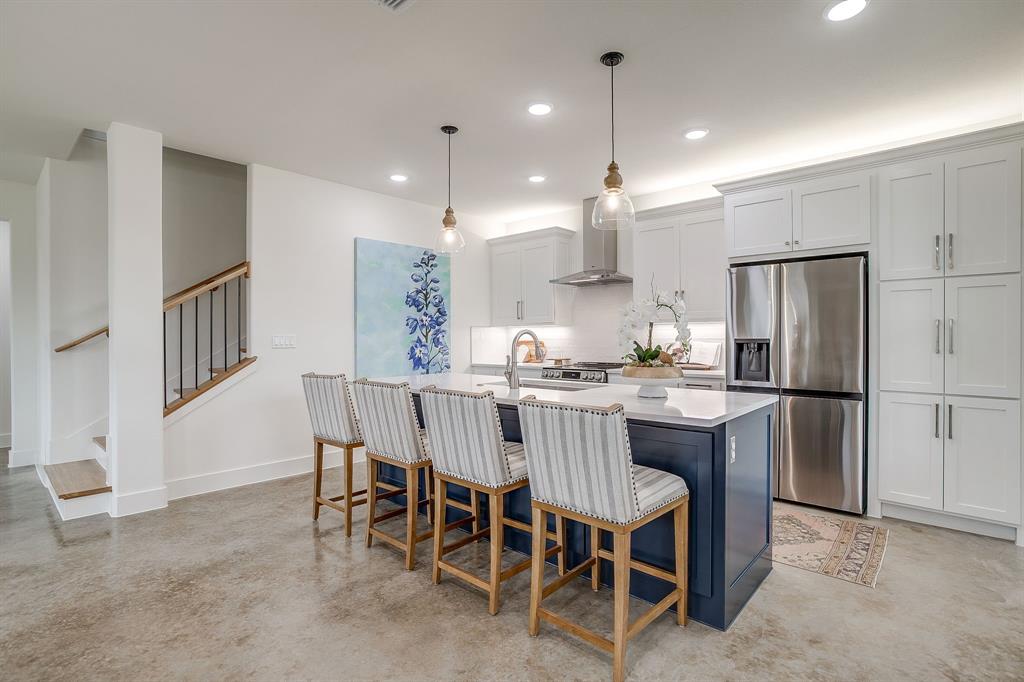 102 Cardinal Wds Granbury, TX 76049 - Photo 8 of 26 a kitchen with a dining table chairs refrigerator and microwave