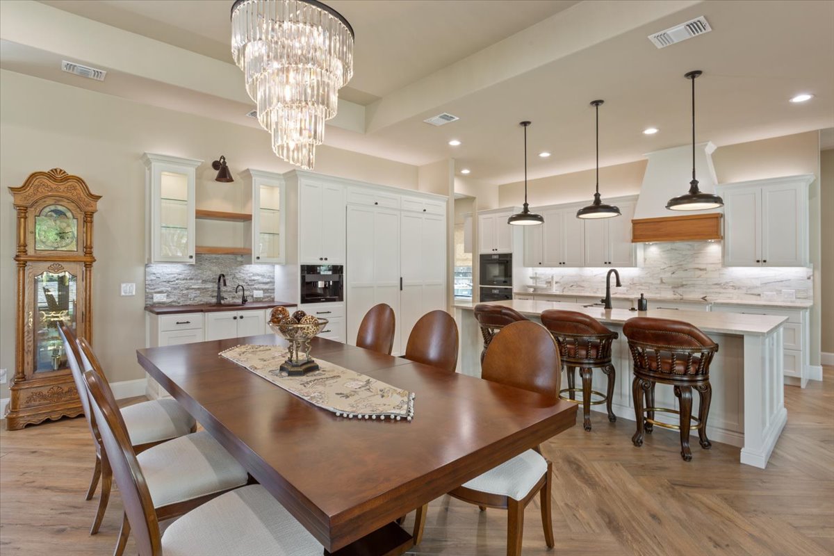 309 Highland Spring Lane Georgetown, TX 78633 - Photo 7 of 40 The table & chairs shown here seat 8. The dining room could easily seat 10-12 plus the breakfast bar area just behind the table...The chandelier? Divine!