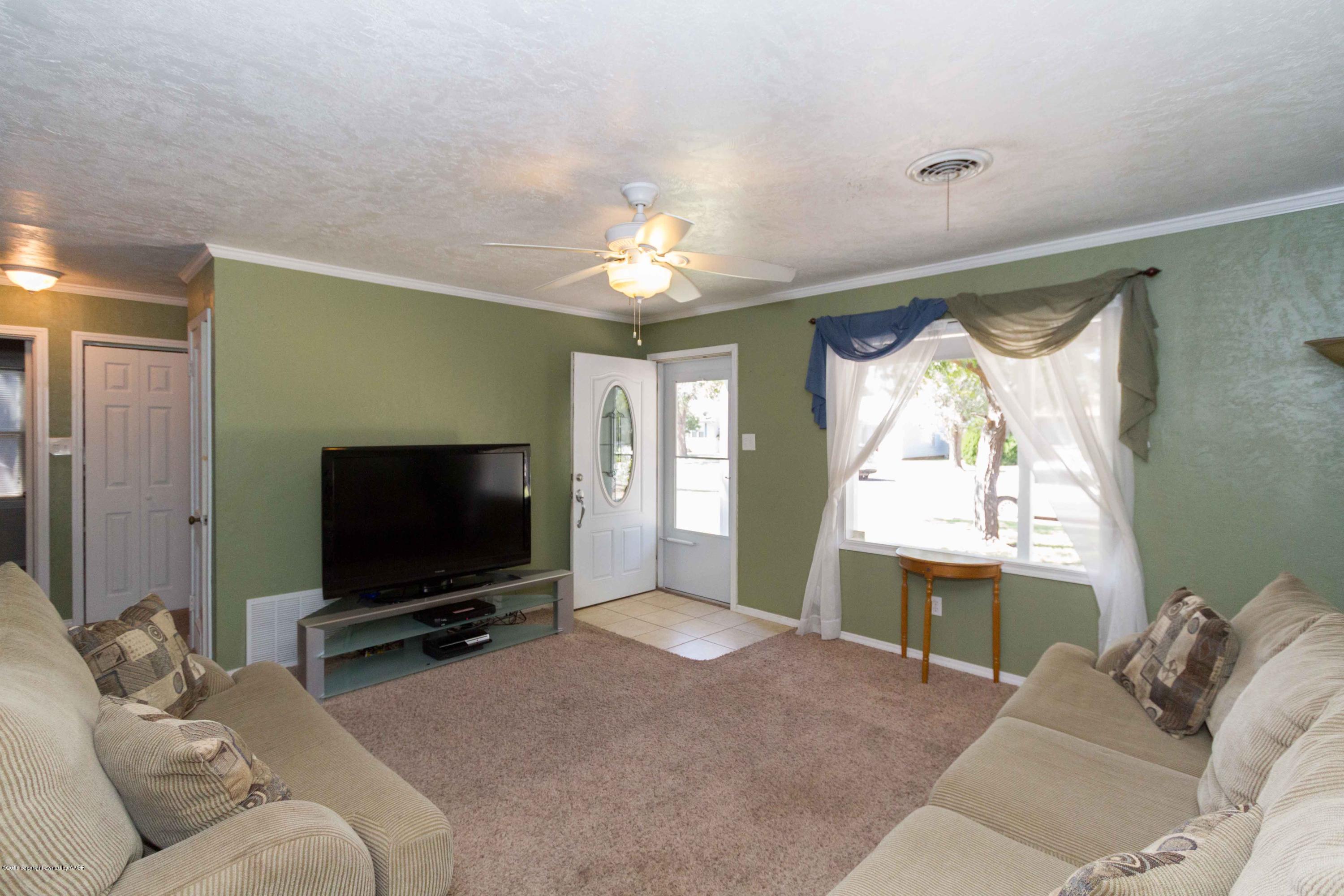 4315 Parker Street Amarillo, TX 79110 - Photo 3 of 24 a living room with furniture and a flat screen tv