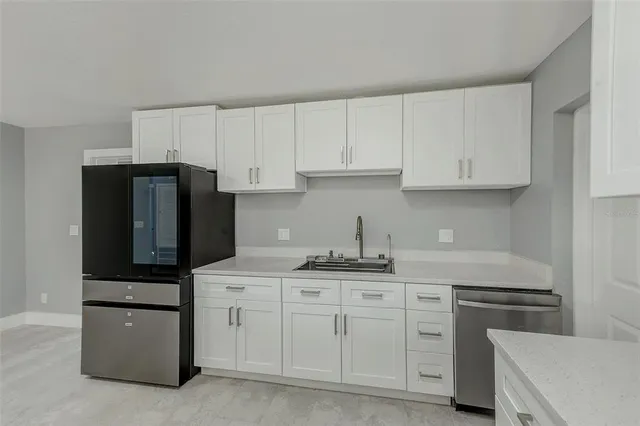 a view of a house with small yard and wooden fence