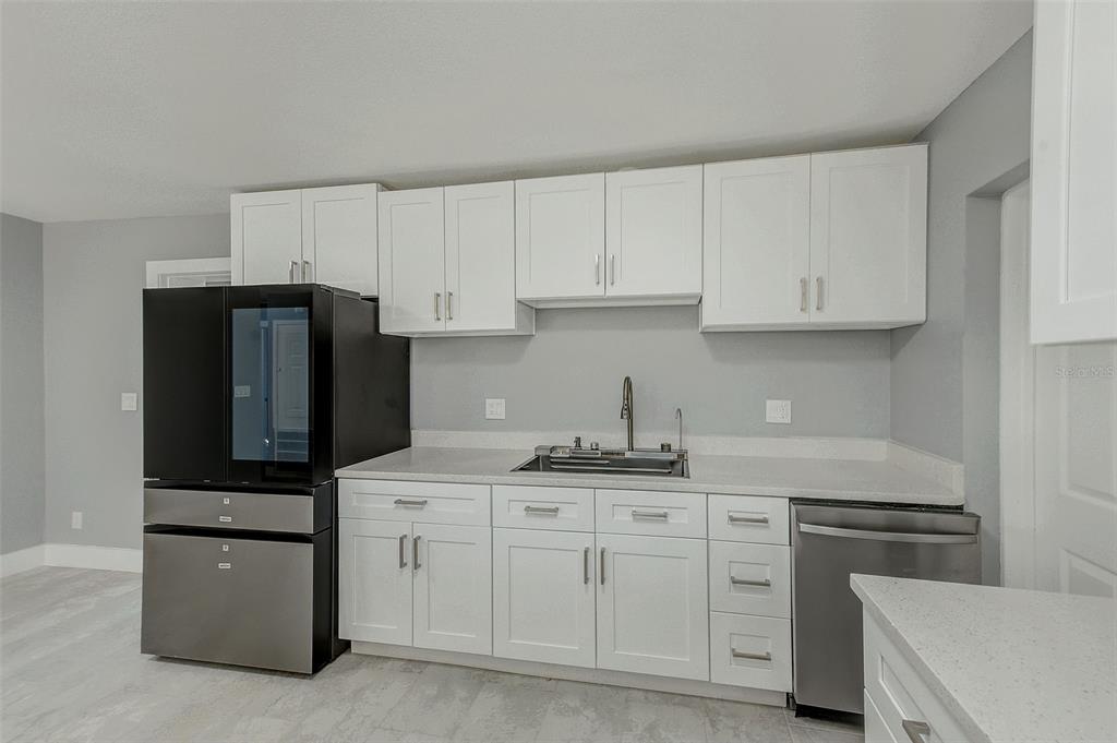 6208 Florida Circle East Apollo Beach, FL 33572 - Photo 13 of 43 a kitchen with cabinets stainless steel appliances and sink