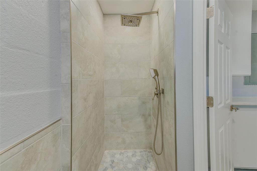 6208 Florida Circle East Apollo Beach, FL 33572 - Photo 27 of 43 a bathroom with a glass shower door