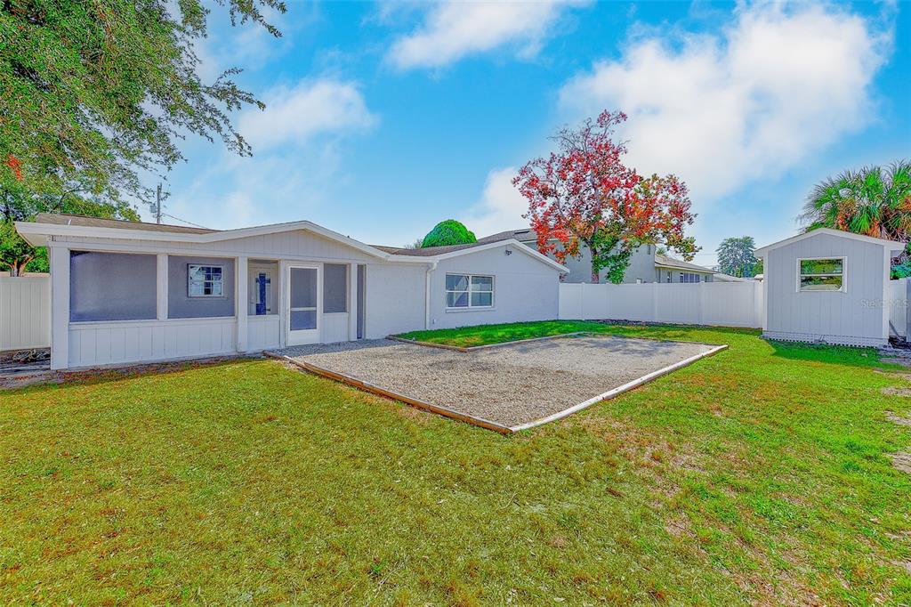 6208 Florida Circle East Apollo Beach, FL 33572 - Photo 32 of 43 a view of a house with a backyard and a tree