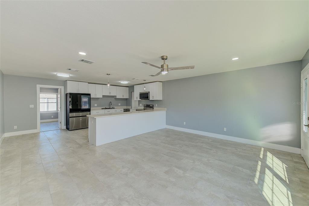 6208 Florida Circle East Apollo Beach, FL 33572 - Photo 4 of 43 a view of kitchen with kitchen island white cabinets and stainless steel appliances