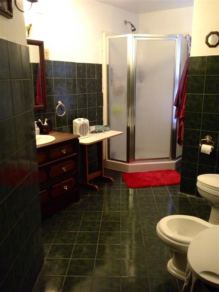 6838 North Bellview Road Freeport, IL 61032 - Photo 16 of 22 a bathroom with a sink mirror vanity and toilet