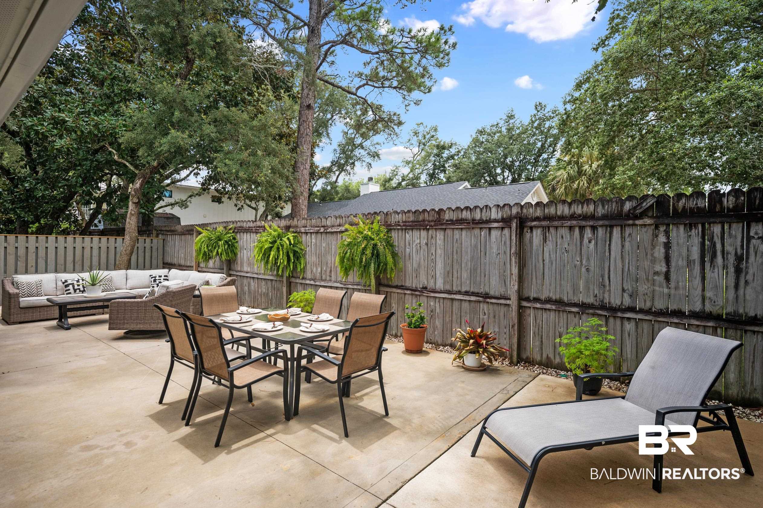 5501 Mobile Avenue Orange Beach, AL 36561 - Photo 21 of 40 Fenced backyard featuring an outdoor hangout area, a patio, and outdoor dining space