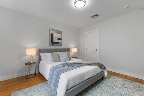 a bedroom with a bed and a lamp