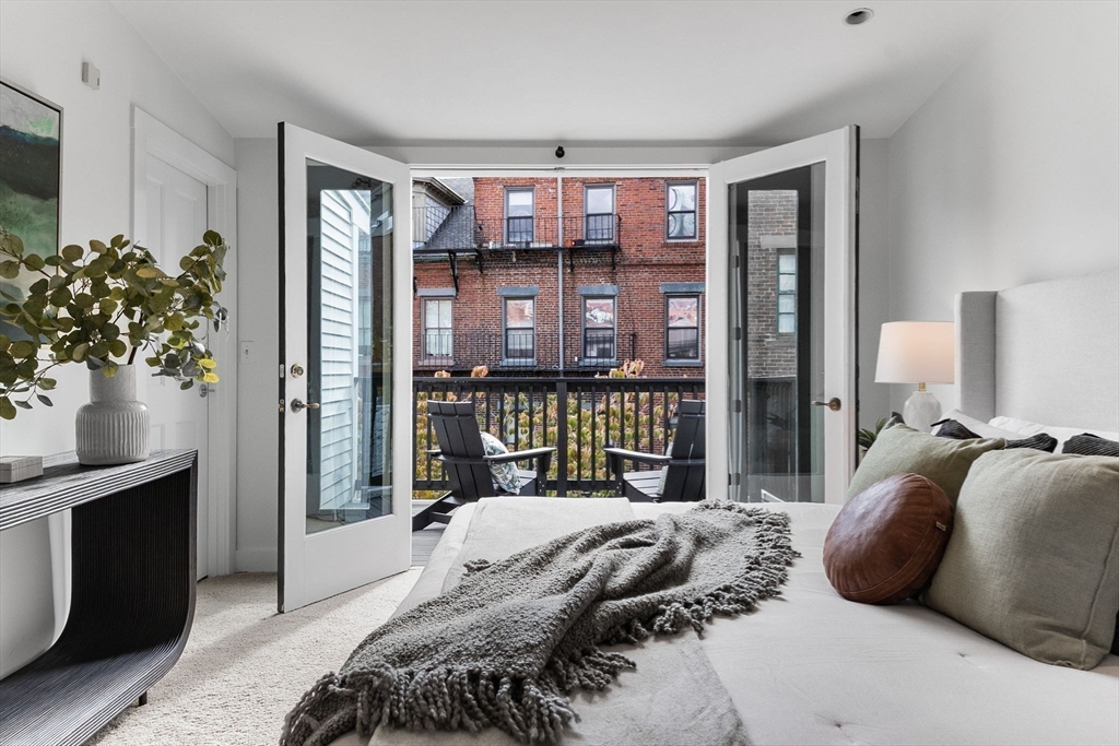 9 Bond Street Boston, MA 02118 - Photo 18 of 21 a bedroom with a large bed and a potted plant