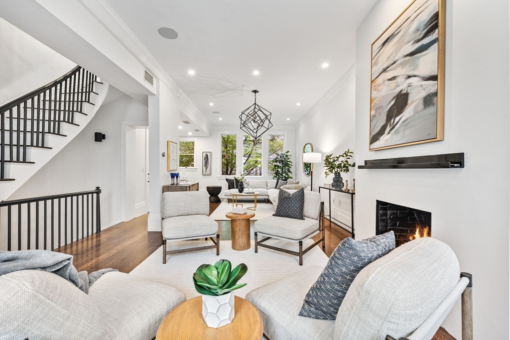 9 Bond Street Boston, MA 02118 - Photo 2 of 21 a living room with furniture a fireplace and a chandelier