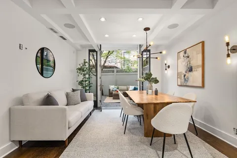 a living room with furniture a window and a chandelier