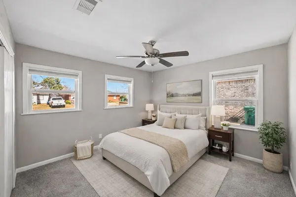 a bedroom with a large bed and a window