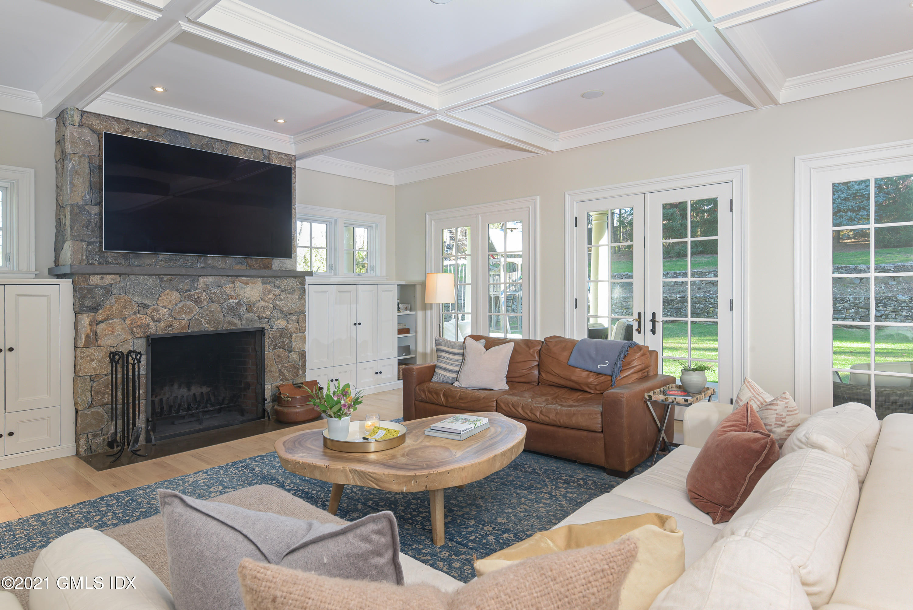 44 Glen Avon Drive Riverside, CT 06878 - Photo 11 of 39 a living room with furniture a fireplace and a flat screen tv
