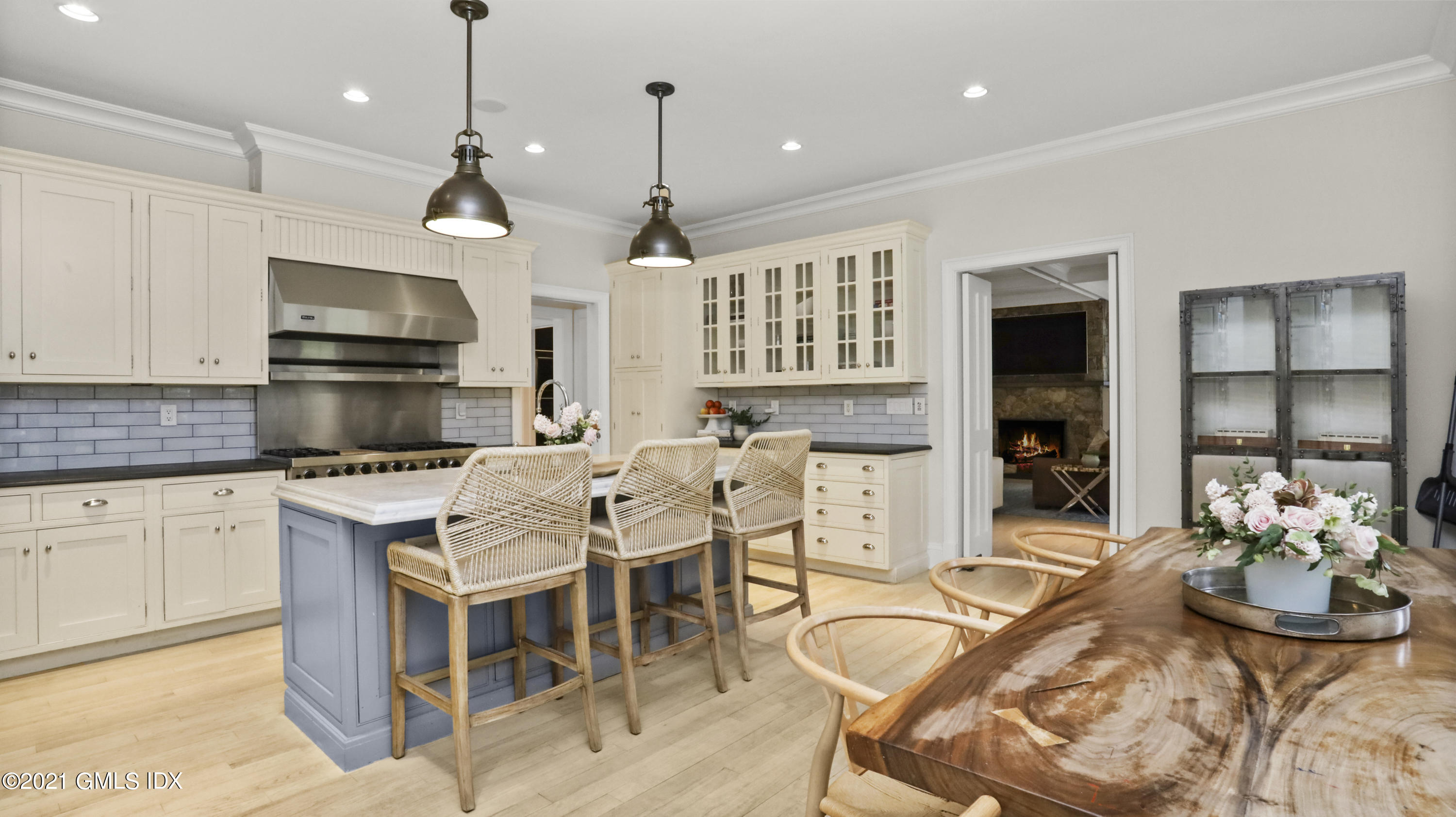 44 Glen Avon Drive Riverside, CT 06878 - Photo 14 of 39 a kitchen with stainless steel appliances kitchen island granite countertop a stove a sink a dining table and chairs