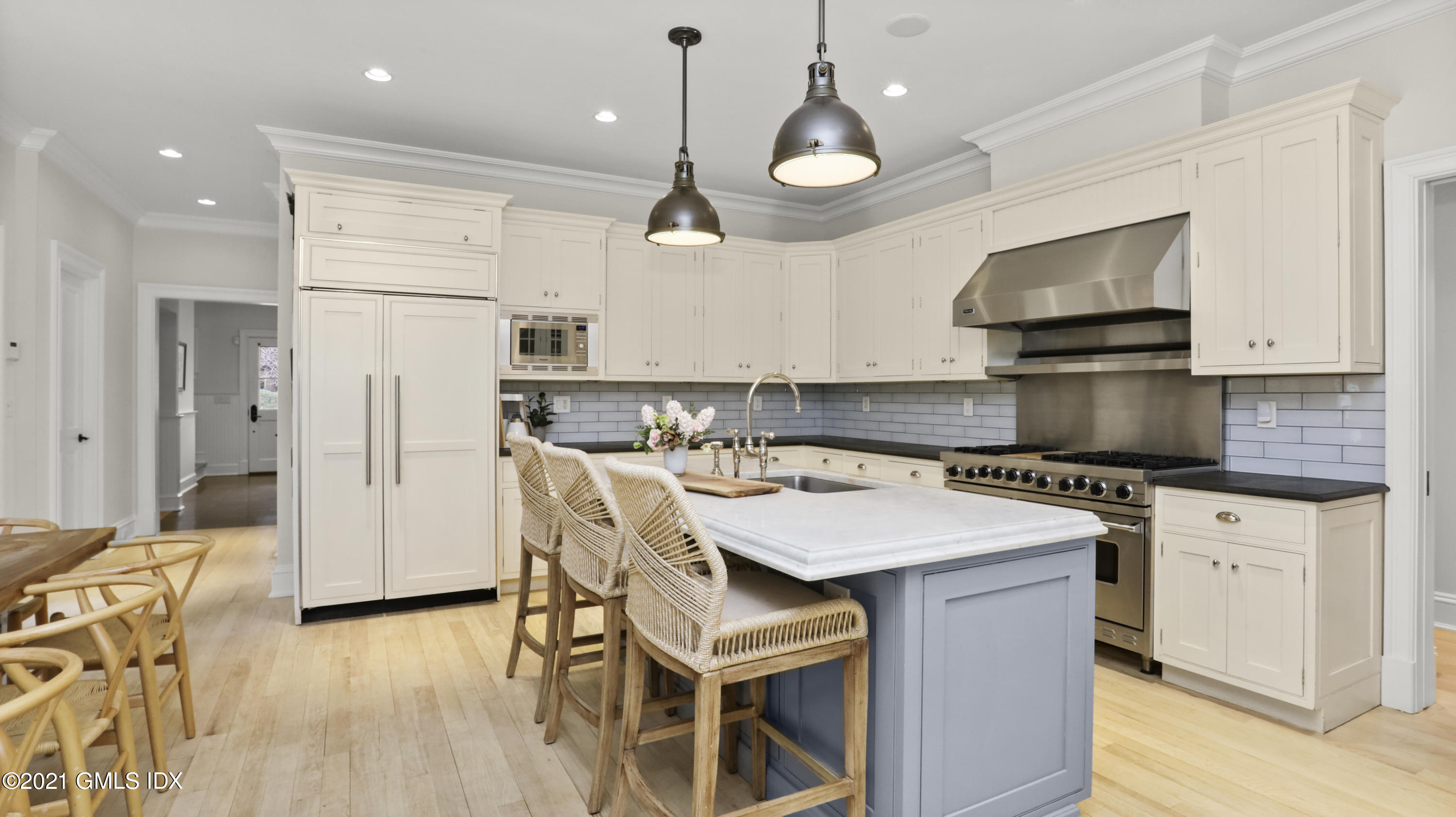 44 Glen Avon Drive Riverside, CT 06878 - Photo 15 of 39 a kitchen with a refrigerator a stove top oven a sink dishwasher and white cabinets with wooden floor